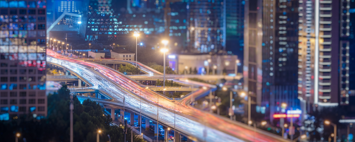 Modern urban highway and skyscrapers at dusk